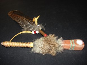 25 inches long,- $80.00. This peace pipe is wrapped in leather, has deer eye guard top, and deer fur for hair.