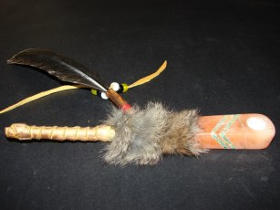 25 inches long,- $80.00. This peace pipe is wrapped in leather, has deer eye guard top, and deer fur for hair.
